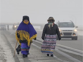 Elizabeth Charlette and Cheryl Bob Redstart walk along the Number 11 highway into Regina Wednesday morning.