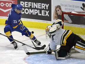 University of Regina Cougars goaltender Andy Desautels stretches for the puck as UBC Thunderbirds forward Luke Lockhart moves in during a Canada West men's hockey game Friday at the Co-operators Centre.