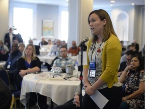 Dr. Melanie Flegel poses a question to Health Minister Jim Reiter at the  Saskatchewan Medical Association's Representative Assembly held in Regina.