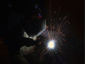 Welding on a gooseneck mount at JR's Welding shop in Regina.