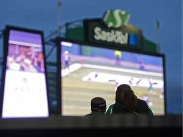 Two people sit in the stands during the last CFL game at old Mosaic Stadium in Regina, Sask. on Saturday Oct. 29, 2016. MICHAEL BELL