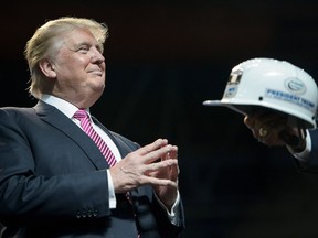 Donald Trump is given a miner's hat during a rally in Charleston, West Virginia last May.