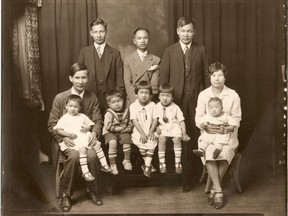Yee Clun (seated left, holding child) took on City Hall in 1924 for the right to hire white women in his Regina restaurant.