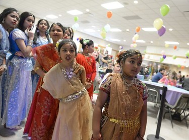 Abida Azad, center left, and other girls of the Bangla Heritage Language School react to a performance taking place on stage at the annual Spring Free from Racism event held at the Italian Club in Regina at 12:53 p.m. on Sunday March 20, 2016.