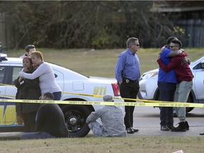 Friends and family of former NFL player Joe McKnight gather at the scene of his shooting death as the Jefferson Parish Sheriff's Office investigates in Terrytown, La., Thursday, Dec. 1, 2016. (Michael DeMocker/NOLA.com The Times-Picayune via AP) ORG XMIT: LAORS101