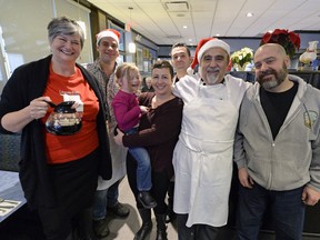 Maria Hendrika, executive director of Regina Transition House, left, stands with Kevin Foley, Bailey Kreutzer, Kelly Lima, Perry Makris, Nick Makris and Art Lima during the 2015 Coffee Day fundraiser at Nicky's Cafe in Regina.