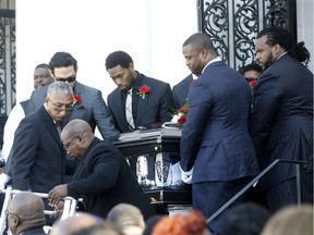 Pallbearers, including Dallas Cowboys quarterback Mark Sanchez, partially obscured left, and former NFL players Bart Scott, second right, and Willie Colon, right, carry the casket of former NFL football player Joe McKnight, after his funeral service at the New Home Family Worship Center in New Orleans, Monday, Dec. 12, 2016. McKnight was shot and killed Dec. 1 during a road rage incident in suburban New Orleans.