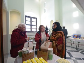 Mary Anne Bachelu, left, Evelyn Bachelu, center, and Shazia Rehman, right, speak during an open house.