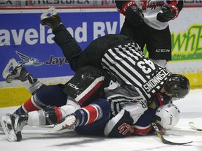 The Regina Pats are ready to renew their rivalry with the Moose Jaw Warriors this weekend. In the above file photo, Moose Jaw's Josh Thrower and Regina's Austin Wagner fall to the ice after a brief tussle on Dec. 17 at the Brandt Centre.