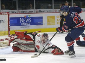 Regina Pats centre Sam Steel has Moose Jaw Warriors goalie Zach Sawchenko at his mercy but can't quite get a handle on the bouncing puck during Saturday's WHL game at the Brandt Centre.