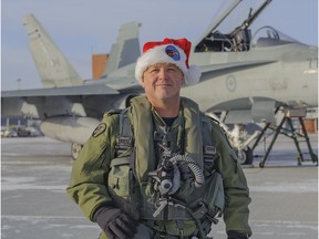 Maj. Denis Bandet, a member of the North American Aerospace Defense Command (NORAD) tracking Santa team, taken on the flight line outside 3 Hangar at 4 Wing, Cold Lake, Alta.