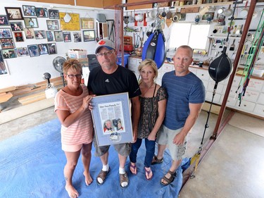 Sharon Kucik, from left, Pat Kucik, Colleen Leaney and Shawn Kucik are Mike Kucik's children who hold up a photo of their late father  who trained boxers in the family garage in the town of Ponteix.