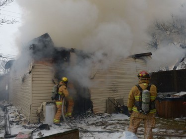 Regina Fire and Protective Services members deal with a garage fire at 1454 Edward St. in Regina, Sask. on Saturday Dec. 3, 2016.