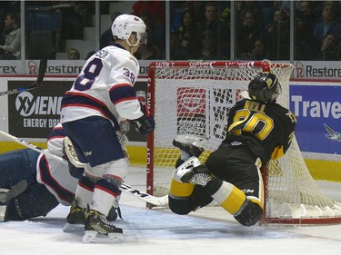 Regina Pats defence Dawson Davidson, 38, gets a penalty for a check that sent Brandon Wheat Kings forward Meyer Nell, 20, into the goal post during a game at the Brandt Centre in Regina, Sask. on Tuesday Dec. 27, 2016.