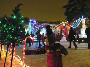 REGINA, SASK - Dec. 14, 2014  -  Elijah Bell reaches for a candy cane decoration as people visit Christmas displays at the home of Mark Jaegli on Champ Cres. in Regina on Sunday Dec. 14, 2014. The event is a fundraiser for the Normanview Residence Group and the Regina Food Bank. (Michael Bell/Regina Leader-Post)