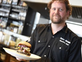 Chef Dave Straub holds a veggie burger at Flip in Regina.