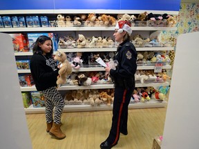 Regina Police Service Sgt. Denise Reavley takes 11-year-old Mikayla Gamble shopping the The Bay in The Cornwall Centre as part of CopShop in Regina.  20 police officers are paired with 20 local children who have been picked as part of the TRiP program to receive a personal shopping experience with a cop.