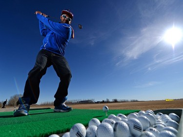 Robel Omikael practices his driving skills at the Paisley Golf Oasis Practice Range in Regina on Friday.