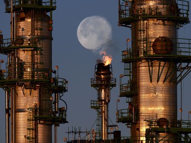 Heat wave distortion from a flare stack at the Co-op Refinery Complex travels through the supermoon in Regina.