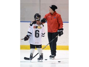 Brandy West-McMaster (right) has made the transition from a star player with the University of Regina Cougars to a hockey coach and mother.