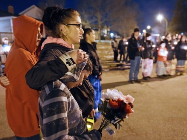 Tara Amyotte comforts Derek Amyotte during a vigil being held to draw attention to violence in North Central and elsewhere in Regina. Derekís father, Derrick Amyotte was murdered in 2012. Tara Amyotte was Derrick Amyotte's sister. Core area community members listened to elders speak and sing honour songs and took part in a sweet grass ceremony and made a public call to end violence.