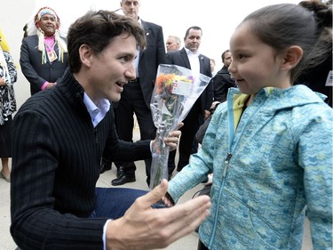 Prime Minister Justin Trudeau meets 7 year old Keslee Bear from Muskowpeetin first nation as he arrives at the Treaty Four Governance Centre in Fort QuíAppelle Saskatchewan Tuesday April 26, 2016 before meeting with the leaders of the File Hills Tribal Council.