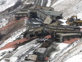 De-railed rail cars hauling potash lay around the tracks of the CP rail line northwest of Craven near Kanata Valley Friday.