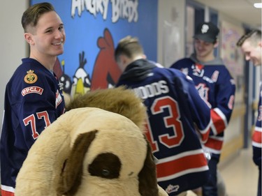 Members of the Pats, including Captain Adam Brooks (L-R) Riley Woods Chase Harrison and Tyler Brown presenting their teddy bears collected during the Teddy Bear Toss at last Friday's game to kids at the Regina General Hospital.