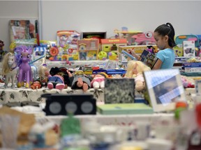 Leah Crowe checks out the toys during Kitchener Community School's Santa shop on Wednesday.