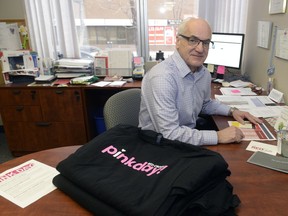 Norm Jakubowski, manager of education in Saskatchewan for the Canadian Red Cross, in his office with some pink shirts – part of the anti-bullying campaign run by the Red Cross.