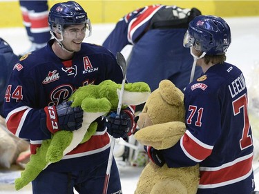 Members of the Regina Pats help collect teddy bears during the Dec. 9 game.