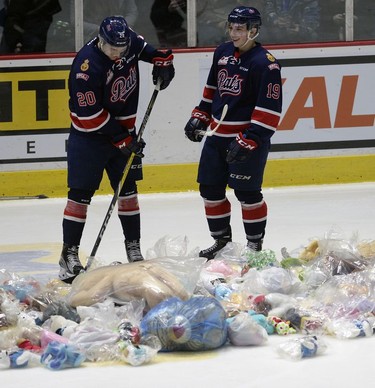 Members of the Regina Pats help collect teddy bears during the Dec. 9 game.