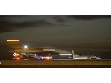 Another plane takes off behind the cargo plane as it sits on the tarmac as no one was injured when a plane went off a Regina International Airport runway on Monday night. Two people were on board the plane, a metroliner cargo aircraft operated by Kelowna-based Carson Air, when its takeoff was aborted at approximately 5:30 p.m., said Regina Airport Authority president and CEO Dick Graham.  The plane ended up sitting about 70 feet off the airport's shorter runway, Graham said.