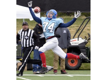 Blue's Jaxon Fuchs can't get ahold of the ball as he tries for an interception during a game between Team #3, blue and Team #4, black in Regina Minor Football's spring league.