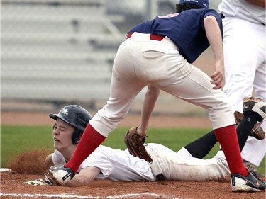 White Sox Ben Flaman beats the play at the plate by Buffalo's pitcher Jamie Crandel  after a passed ball  during a Saskatchewan Premier Baseball League midget AA game between the Regina White Sox and Regina Buffalo at Optimist Park.