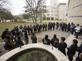 People attend a candlelight vigil outside the Gordon Oakes Red Bear Student Centre on the University of Saskatchewan campus on Oct. 20 to support those affected by the tragedies of youth suicides in northern Saskatchewan. GREG PENDER