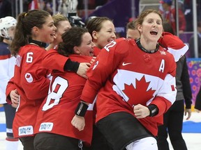 Hayley Wickenheiser (right) celebrating winning a fourth gold medal in women's hockey at the 2014 Winter Olympics in Sochi.