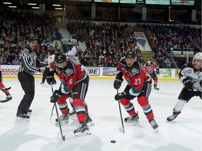 Jonathan Smart (#6) back passes the puck to Calvin Thurkauf (#27) of the Kelowna Rockets.