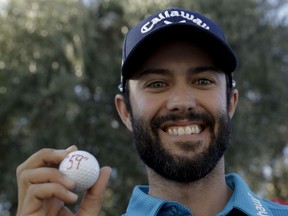 Moose Jaw-born Adam Hadwin celebrates poses after shooting a 59 on Saturday at the PGA's CareerBuilder Challenge in La Quinta, Calif.