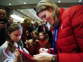 Team Canada women's hockey player and four-time Olympic gold-medallist Hayley Wickenheiser signs autographs in Calgary on Feb. 25, 2014, after arriving home from the Sochi Olympics. Wickenheiser has retired from hockey after 23 years on Canada's women's team.The 38-year-old from Shaunavon announced her retirement on Jan. 13.
