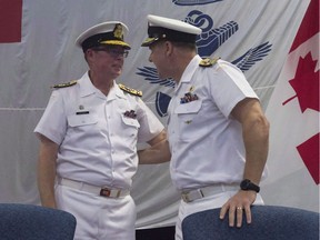 Royal Canadian Navy Vice-Admiral Mark Norman (left) speaks with Vice-Admiral Ron Lloyd during a change of command ceremony Thursday, June 23, 2016 in Ottawa. Norman, one of the military's highest-ranking officers, has been temporarily removed from his post.