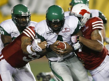 While attempting a 2-point conversion against the Montreal Alouettes, Saskatchewan Roughriders quarterback Darian Durant is wrapped up by Anwar Stewart and John Bowman of the Als only to wiggle free and make a scoring pass. This was during a CFL game Friday, August 21, 2009 at Percival Molson stadium in Montreal.