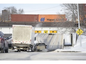 A large commercial truck heads northbound on Winnipeg Street under the underpass between Dewdney Avenue and 8th Avenue.