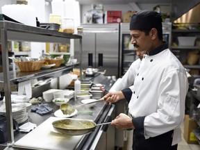 Head chef Vinu Paily plates some food at Tamarind restaurant in Regina.