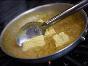 Head chef Vinu Paily prepares some salmon in turmeric at Tamarind restaurant in Regina.