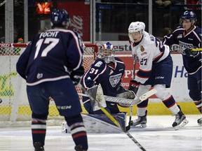 Regina Pats forward Austin Wagner screens Tri-City Americans goalie Evan Sarthou while a shot from Conner Hobbs (not pictured) goes into the net during WHL action at the Brandt Centre on Friday.