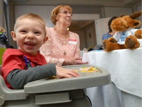 Tyler Evans, left, sits in a highchair as his grandmother Gaylene looks on at the Telemiracle 41 launch and cast announcement held at the Hotel Saskatchewan. Telemiracle supported Tyler, who has cerebral palsy and has seizures, by giving his family a specialty bed that keeps him safe when he's left alone.