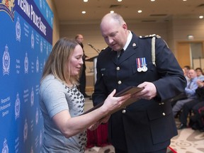 REGINA, SASK : January 26, 2017 - Annette Vaxvick, a nurse, accepts an award from Regina Police Services chief Evan Bray during a ceremony held at the Delta Hotel. MICHAEL BELL / Regina Leader-Post.