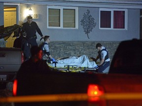 Paramedics move a man from a house to an ambulance at 919 Shannon Rd. He had arrived at that home with gunshot wounds.