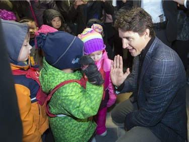 Prime Minister Justin Trudeau greets some little children during his walking tour on the University of Regina campus in Regina.